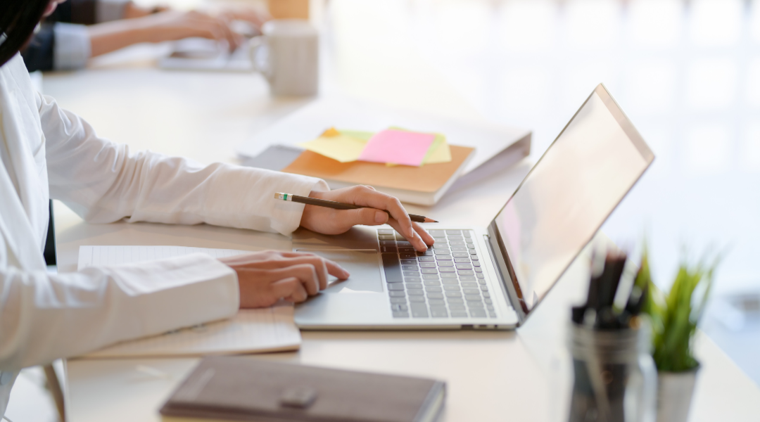 An office employees using a laptop. DPM Surface Care