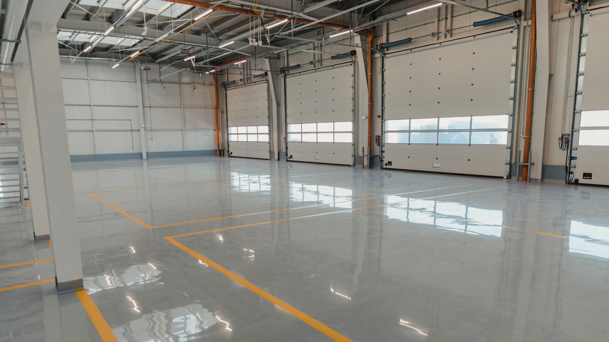 A large warehouse with concrete floor with epoxy coatings. DPM Surface Care