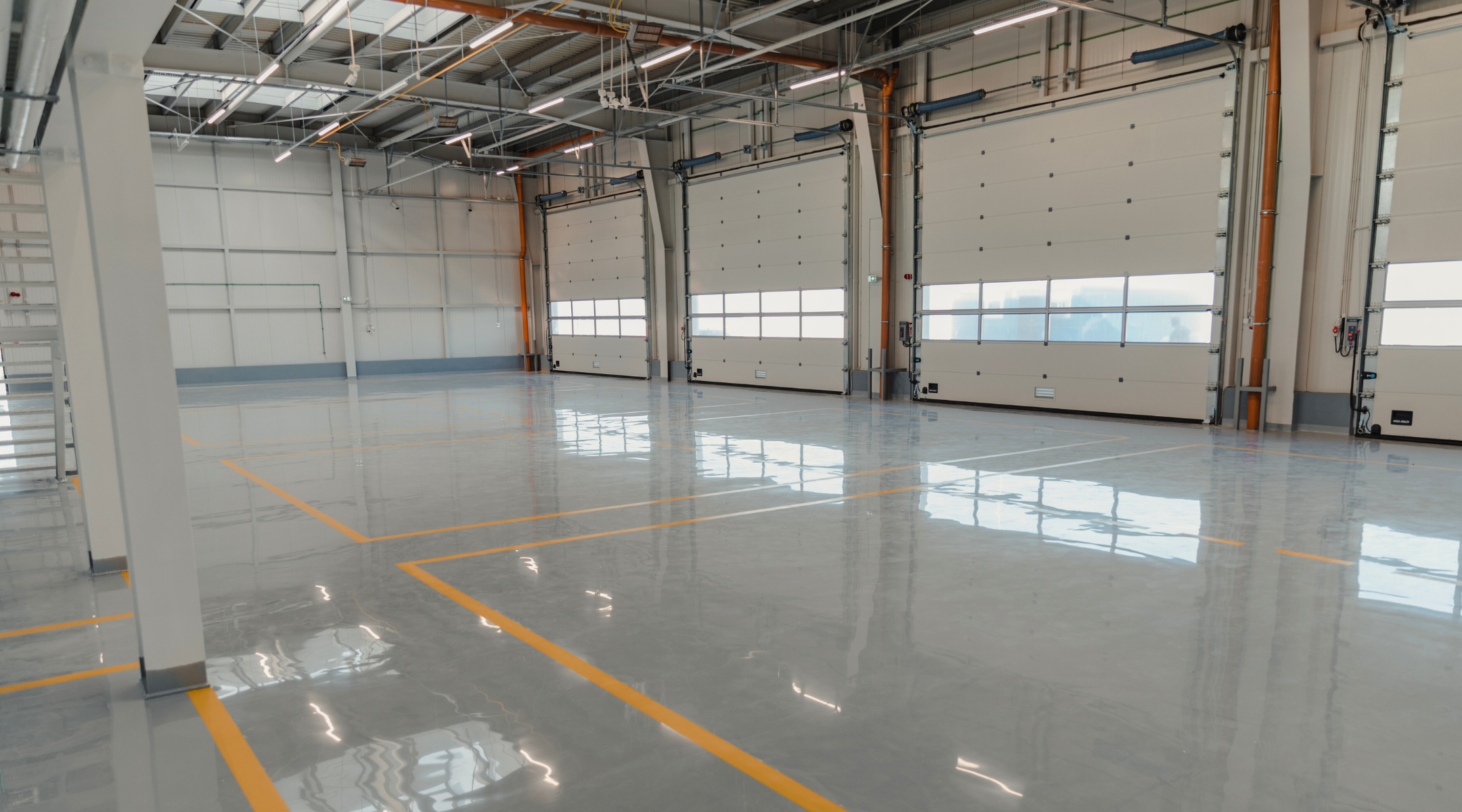 A large warehouse with concrete floor with epoxy coatings. DPM Surface Care