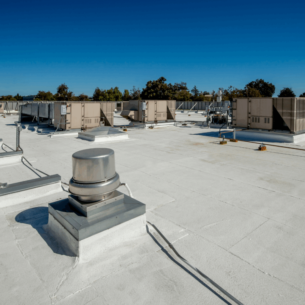 A rooftop with air conditioning units and white concrete floor. Roof cleaning. DPM Surface Care