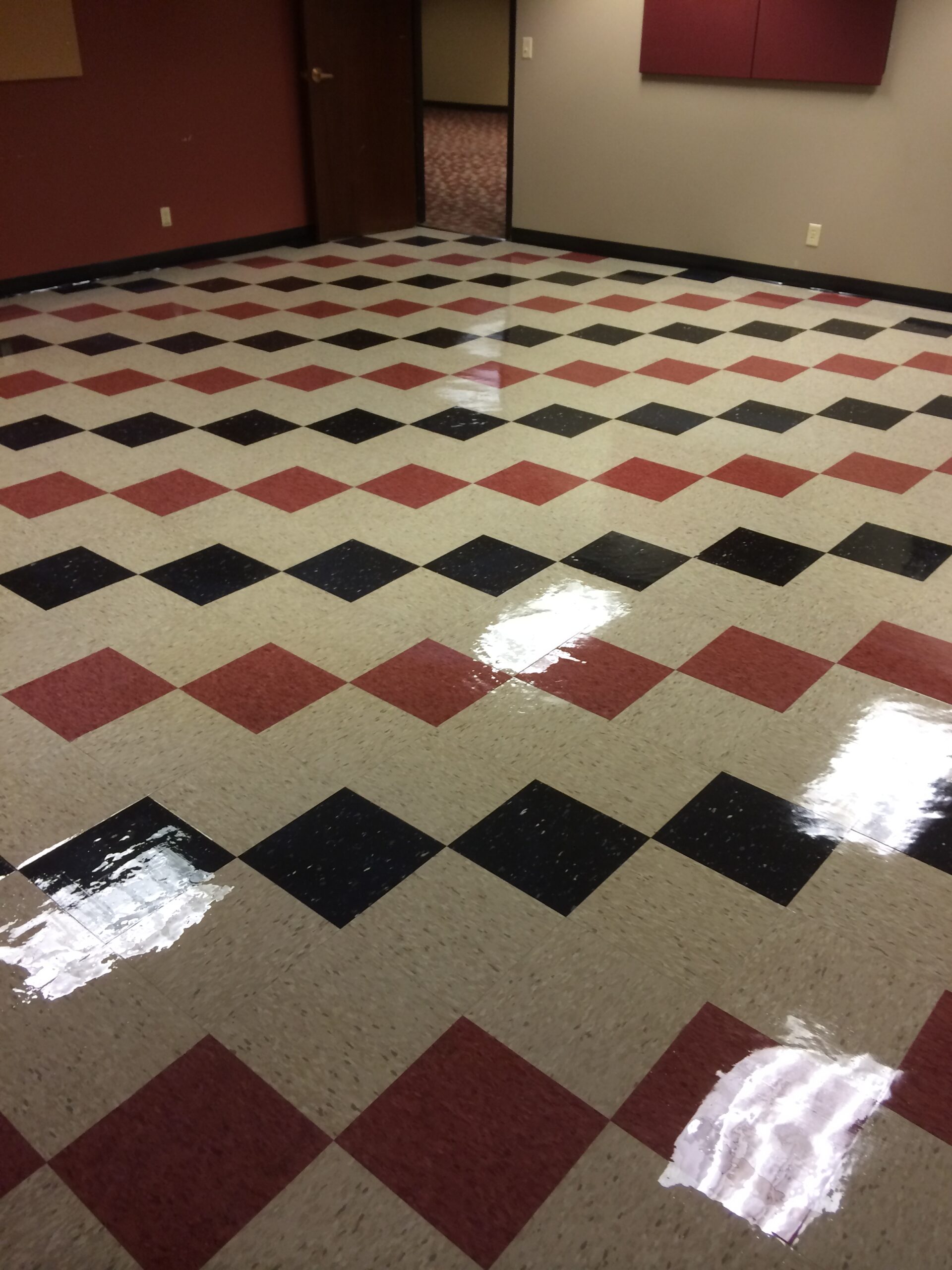 A tiled black and red checkered floor with high performance coatings. DPM Surface Care