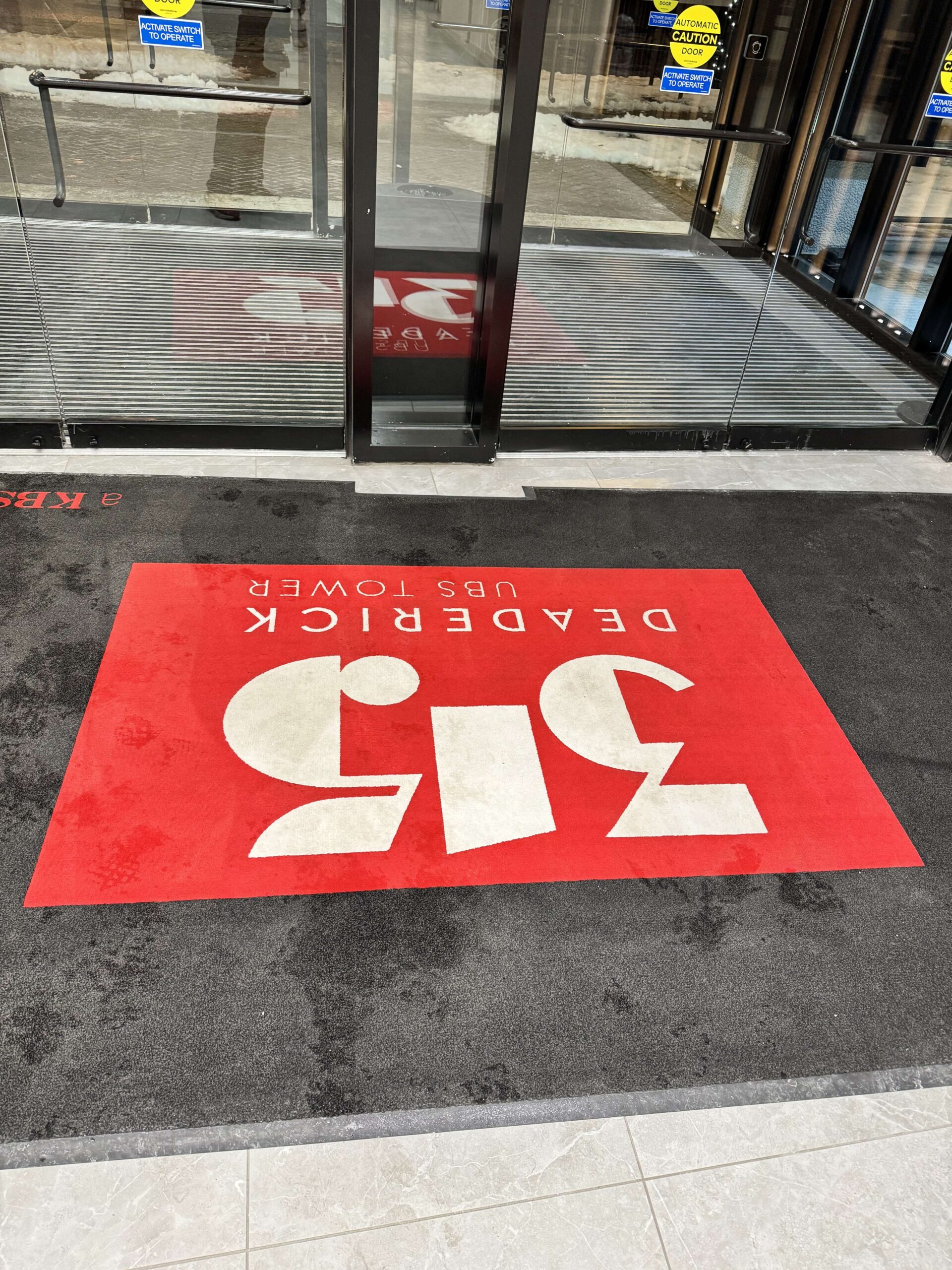before – rug A dirty red and white carpet on the entrance of Deaderick UBS Tower. DPM Surface Care