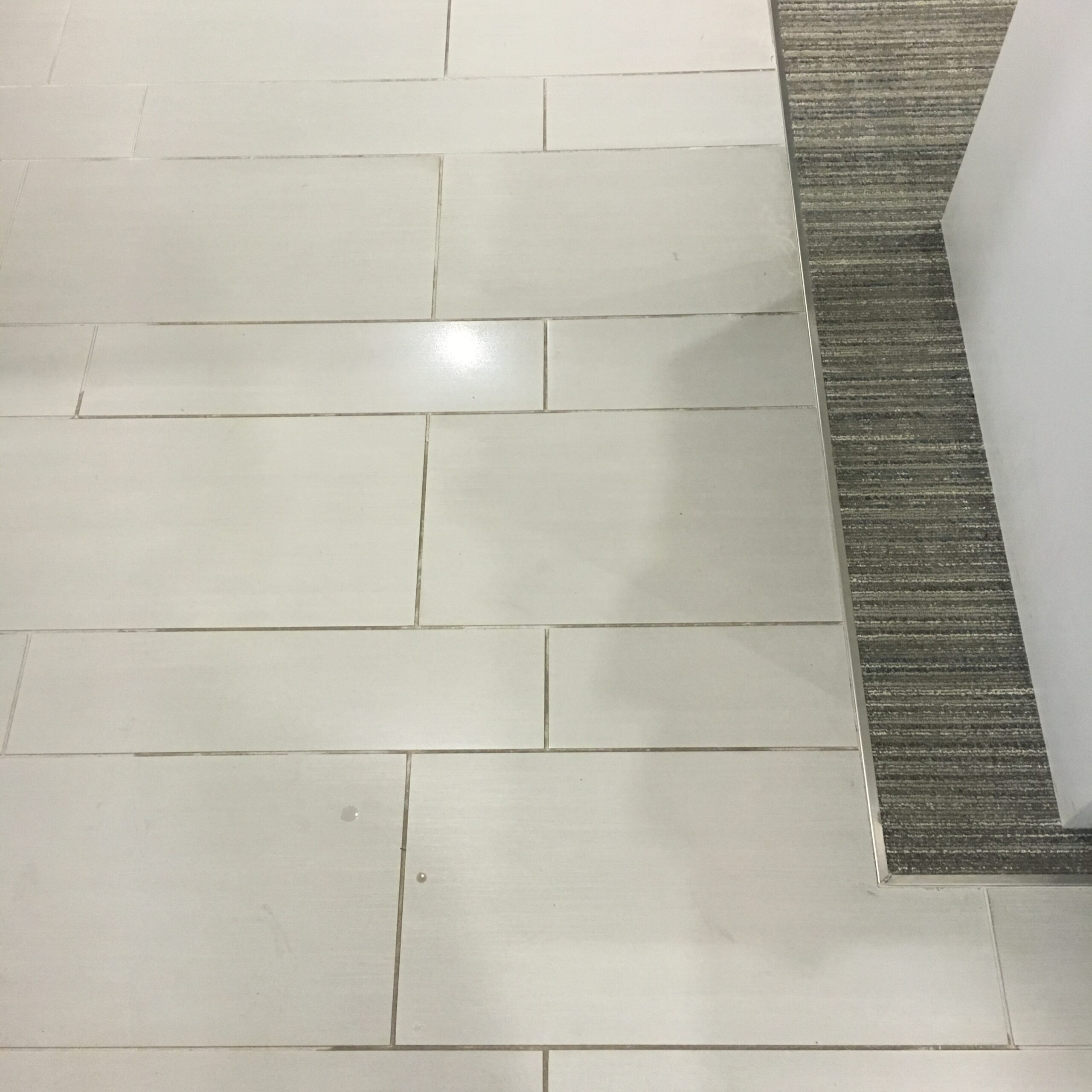 tile before A white tile floor with dirty grout. DPM Surface Care
